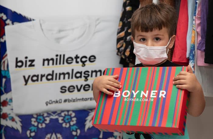 A child carrying a Boyner donation package